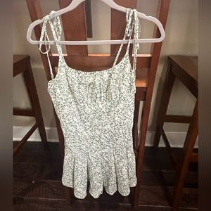 green and white floral romper with adjustable tie shoulders